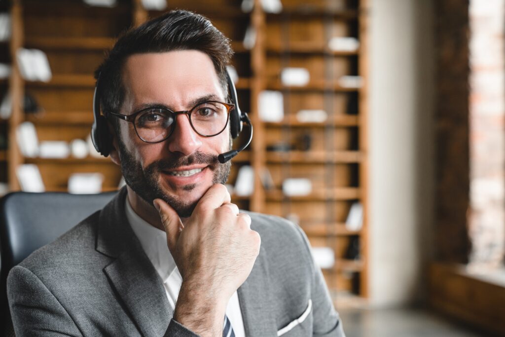 Closeup young it support manager in headset working remotely in office.