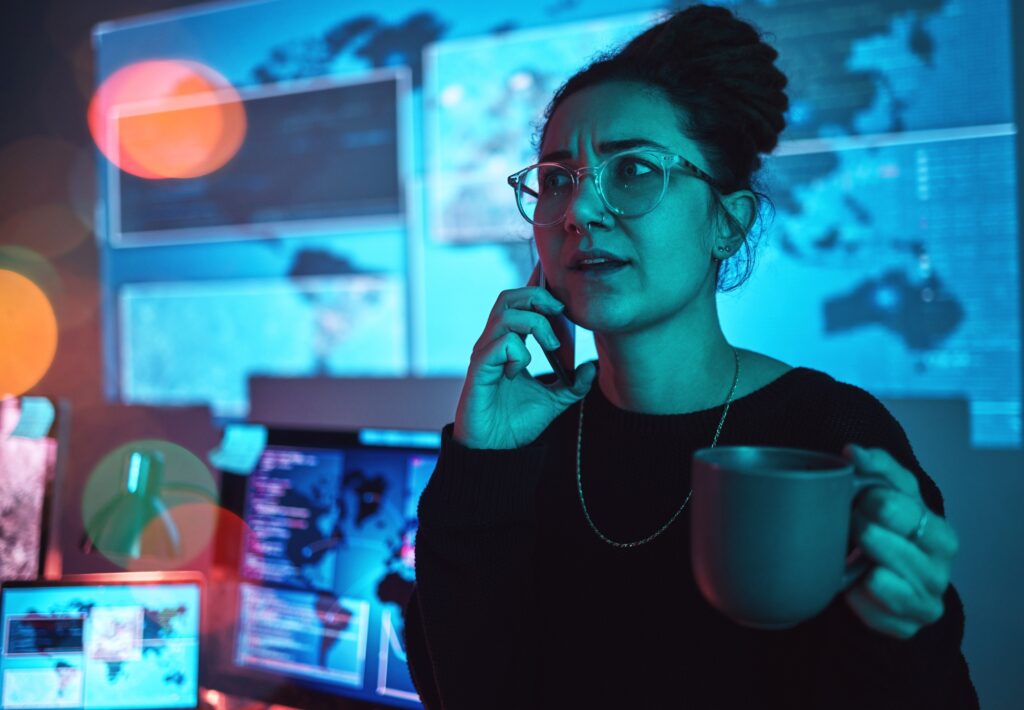 Night, coffee and a woman hacker on a phone call during a cyber security emergency in her office. C