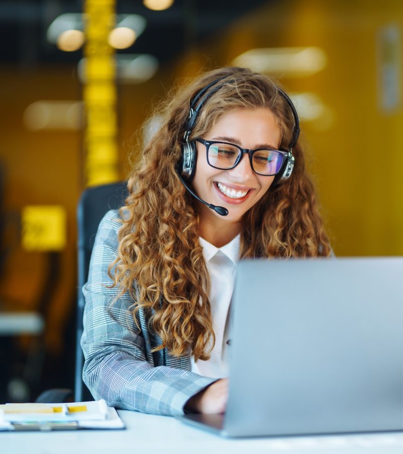 Call center agent with headset working on support hotline in modern office. Video conference. Call center agent with headset working on support hotline in modern office. Video conference.